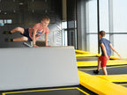 Zwei Kinder beim Springen und Klettern im Trampolinbereich des Cube Funpark Beselich mit modernen Hindernissen