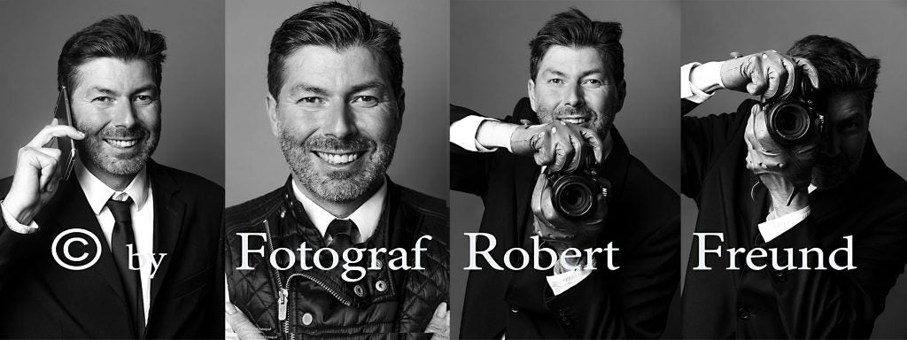 Porträt von Fotograf Robert Freund aus Düsseldorf mit Kamera und im Anzug